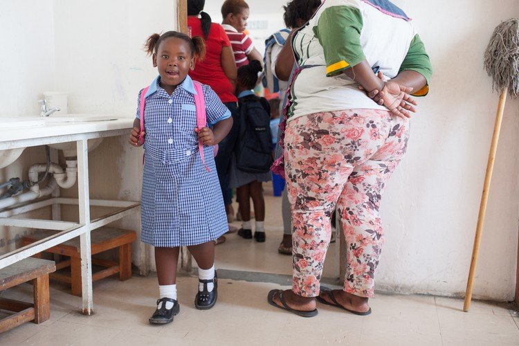 A young learner receiving attention during the first school day